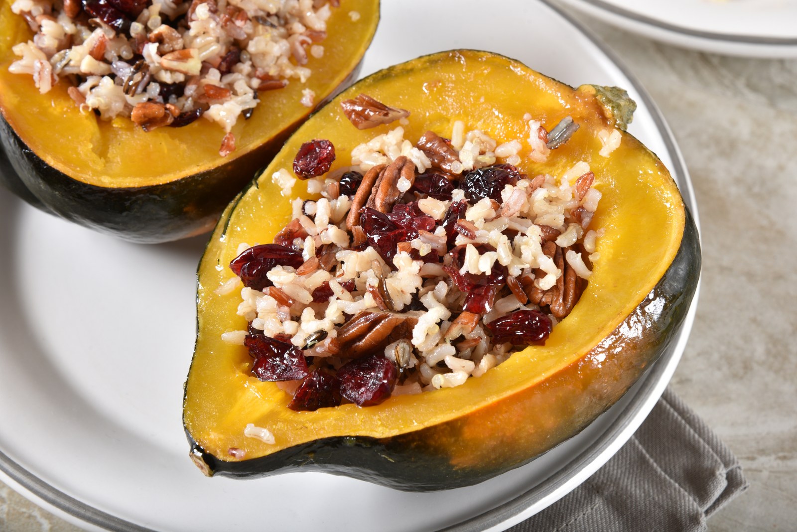 Stuffed Acorn Squash with Wild Rice, Cranberries, Pecans & Herbs